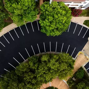 Aerial shot of freshly paved and striped parking lot outside of a condominium