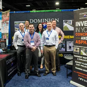 Dominion Paving Employees Standing in front of Pop-Up Display