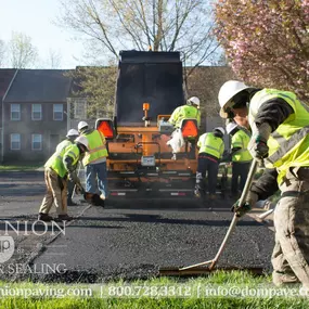 Dominion Paving Employees laying fresh asphalt