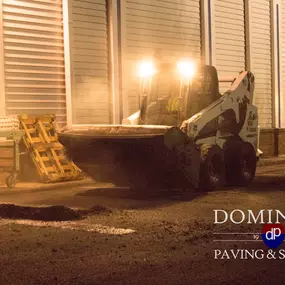 Dominion Paving Contractor operating a Bobcat