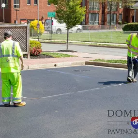 Dominion Paving Contractors Measuring Parking Lines in Parking Lot