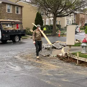 Dominion Paving Employee holding a piece of lumber