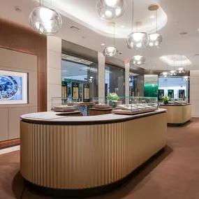 Our Rolex showroom features gorgeous hand-blown glass chandeliers hanging over some of the most modern display vitrines on the market.  The walls are meticulously lined with wood and limestone tiles in which every grain is aligned seamlessly, creating the impression every wall is cut from a single block of wood.