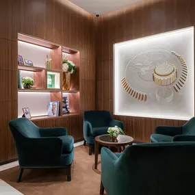 There is an open-air lounge with a library of Rolex aficionado books and a beautiful Rolex artwork of the Skydweller watch movement created out of Stucco and leather to create a 3D impression. Clients can sit and sip a beverage while looking in through the window of our Rolex service department and observe our highly skilled watchmaker technicians work on servicing watches or simply relax and bask in the brilliance of their surroundings.
