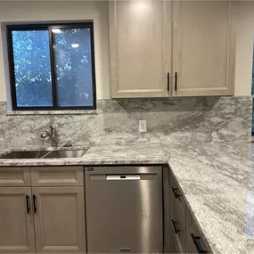 A fresh kitchen remodel showcasing custom cabinetry, durable quartz countertops in white and gray, and high-end stainless steel appliances. Designed for everyday function and modern elegance, this space blends clean lines with quality materials for a stunning, practical finish.