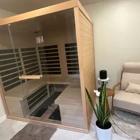 This custom spa room remodel features a built-in wood-paneled sauna and a serene seating area designed for relaxation and wellness. The calming design, warm tones, and thoughtful layout create a private retreat that blends function with luxury.