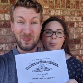 Making silly faces while holding up the Hammonds Media business license.