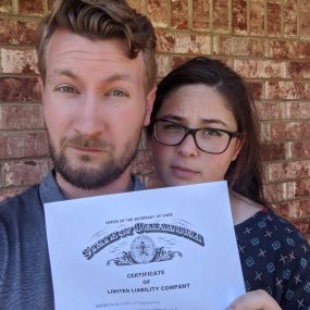 Making serious faces while holding up the Hammonds Media business license.