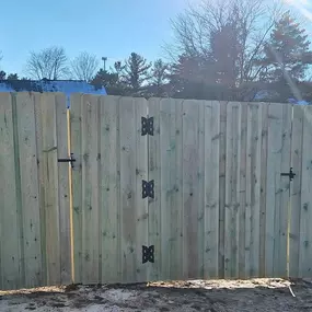 Six-foot-tall treated Pine Dog Ear privacy fence with single swing gate.