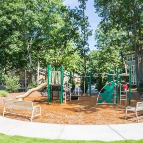 Outdoor playground with seating benches.