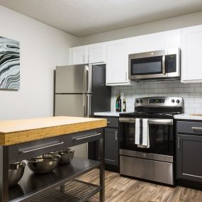 Spacious kitchen with stainless steel appliances and ample storage space.