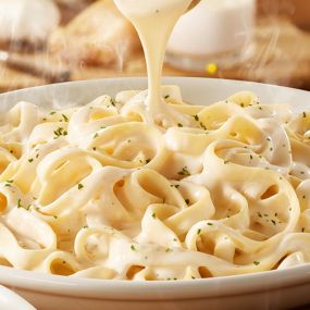 Fettuccine Alfredo: Our signature alfredo made fresh in-house every day, served over fettuccine.