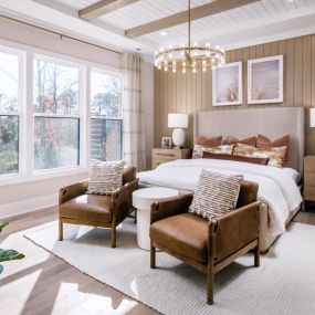 Spacious primary bedroom suite with tray ceiling