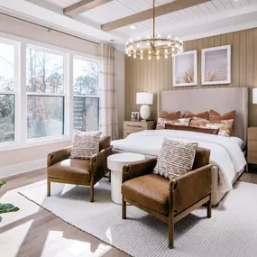 Spacious primary bedroom suite with tray ceiling