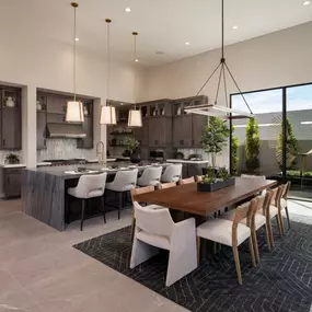 Beautiful kitchen with waterfall island, upgraded cabinets, and casual dining area