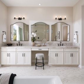 Lavish primary bathrooms with dual-sink vanities, freestanding soaking tub, and walk-in shower