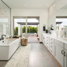 Luxurious primary bathrooms with access to backyard