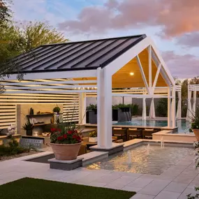 Serene backyard space complete with a pavilion, pool, and water features