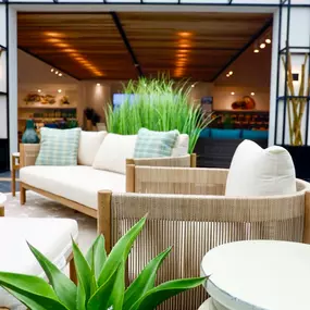 Modern outdoor seating with natural greenery in a stylish patio showroom.