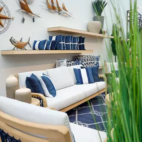 Coastal-inspired patio furniture display with nautical decor accents.