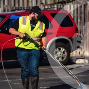 Blue Curb LLC Contractor Using a Power Washer