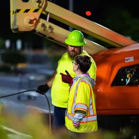 Two Blue Curb, LLC Contractors Talking to One Another