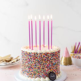 Sprinkles and smiles for every occasion! This fun, vibrant cake covered in rainbow sprinkles is sure to brighten up any celebration.