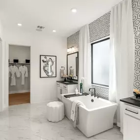 Lavish primary bathrooms with large walk-in showers and freestanding soaking tubs