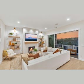 Open great room with expansive sliding doors to the covered deck