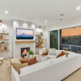 Open great room with expansive sliding doors to the covered deck