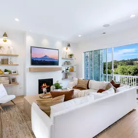 Open great room with expansive sliding doors to the covered deck