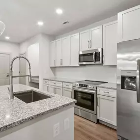 Spacious kitchen with stainless steel appliances and kitchen island.