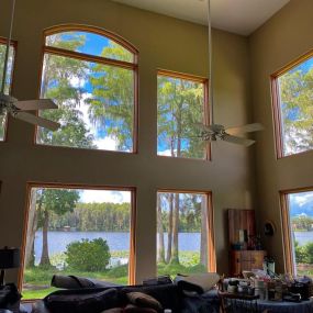 This image showcases the elegant interior of a lakefront home in Palm Harbor, Florida, with windows treated by Precision Safety Films, PSF Window Tinting. The company has expertly installed tinted window film to reduce heat, sun glare, and UV damage.