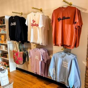 Glimpses of fall are starting to show in the shop! We have lots of new goodies! New apparel and cards just hit the shelves!