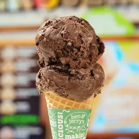 Mochaccino Chip Non-Dairy in a sugar cone at a Ben & Jerry's ice cream shop.  Mochaccino Chip is Chocolate Coffee Non-Dairy Frozen Dessert with Caramel Swirls & Fudge Flakes.