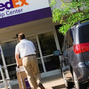 A customer dropping packages at FedEx Ship Center