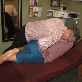 Dr. Pontious performing a spinal adjustment.