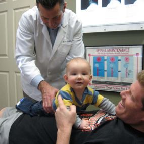 Dr. Pontious performing adjustment on a baby.