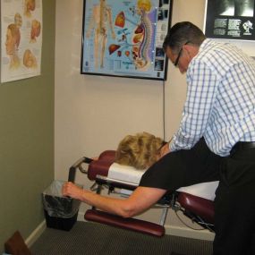 Dr. Pontious performing neck adjustment on Leander Table.