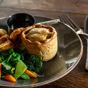 Handmade steak & ale pie, skin-on chips, peas, gravy.