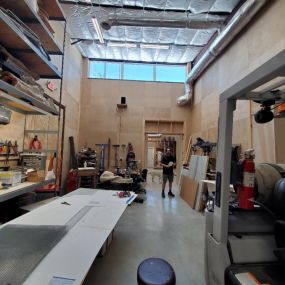 Elongated windows at the top of the studio walls bring natural daylight into this Sculptors working studio space.