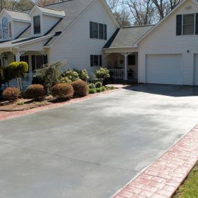 Before pouring any new concrete residential driveway, proper grading is essential to prevent water pooling on the finished driveway. We create a slight slope to facilitate drainage, directing water away from your home and into appropriate drainage systems.