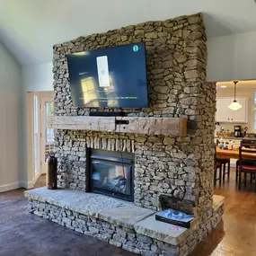 Mantel and stone clad fireplace making a significant design statement in this Sandy Springs home improvement project