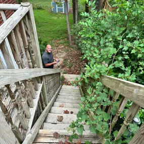 Do you need of an estimate for a home improvement project? Schedule your free estimate via our website. Here one of our project managers is diligently measuring an Atlanta home for all new exterior woodwork, from stairs to decking and landings.