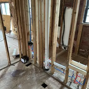 Here we see the structural preparation required for electrical rough-in. All wall studs and framing have dried after storm water damage, and are clear to support new electrical wiring installations.