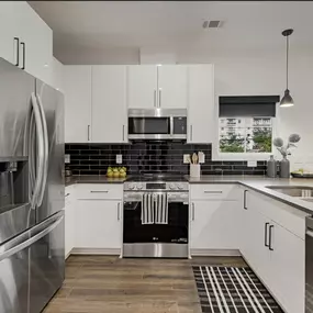 Smart design meets style in this budget-friendly kitchen remodel! By opting for classic white cabinets paired with black and white fixtures and tiles, we created a sleek, modern look without stretching the budget.