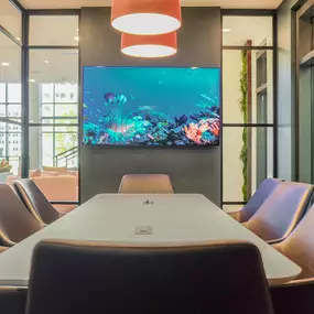 a conference room with a table and a fish tank