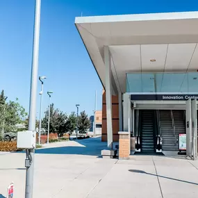a metro station with a metro sign in front of a building