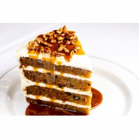 WORLD CLASS CARROT CAKE cream cheese icing, spicy pecans and warm butterscotch
