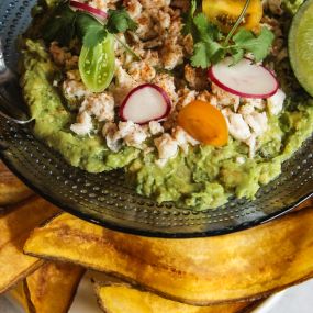 BLUE CRAB GUACAMOLE fresh lime, plantain chips on the snacks, dips and bites bar menu.